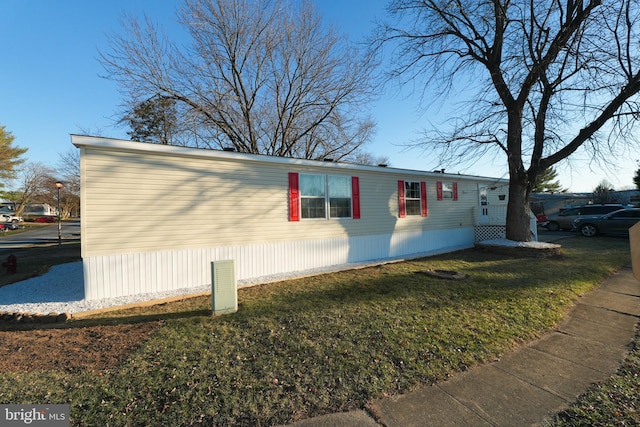 view of side of property with a yard