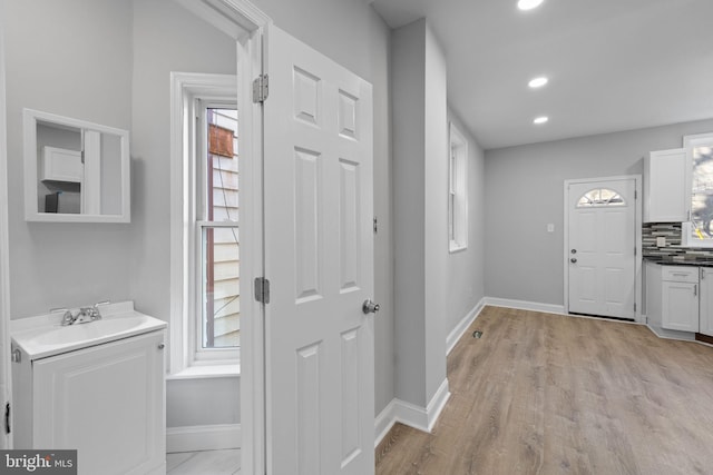 entryway featuring light wood-type flooring and sink