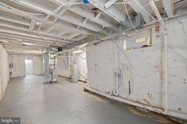 basement featuring heating unit and water heater