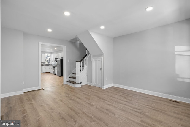 unfurnished living room featuring light wood-type flooring