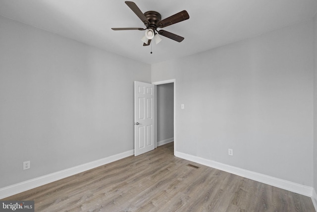 spare room featuring ceiling fan and light wood-type flooring