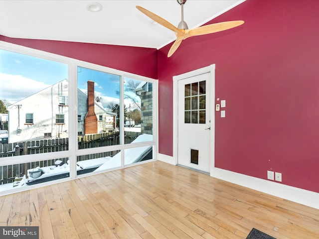 interior space featuring hardwood / wood-style flooring, ceiling fan, and vaulted ceiling