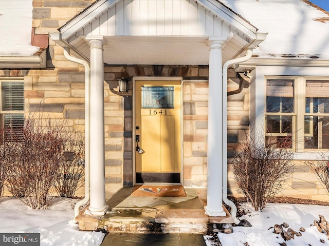 view of snow covered property entrance