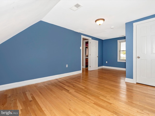 interior space featuring light hardwood / wood-style flooring and lofted ceiling