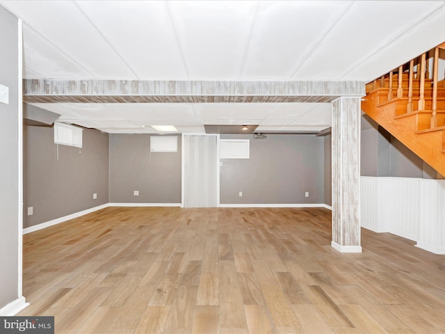 basement with light hardwood / wood-style flooring