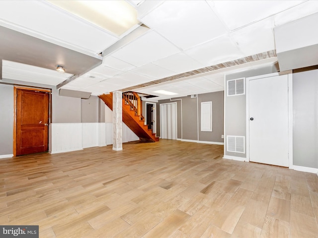 basement with light hardwood / wood-style flooring