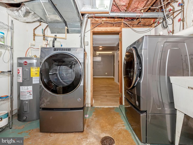 clothes washing area with sink, washer / clothes dryer, and water heater