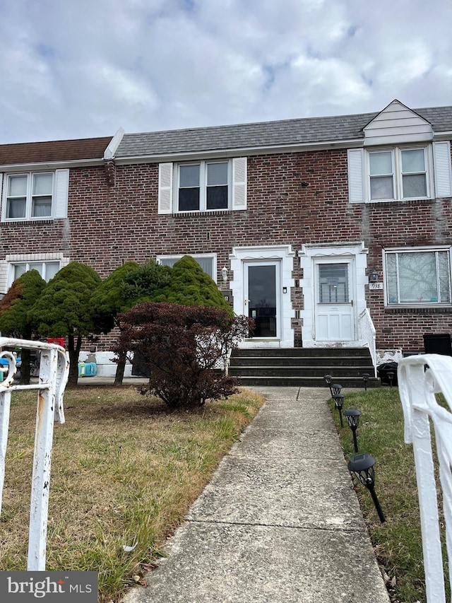 view of property featuring a front lawn