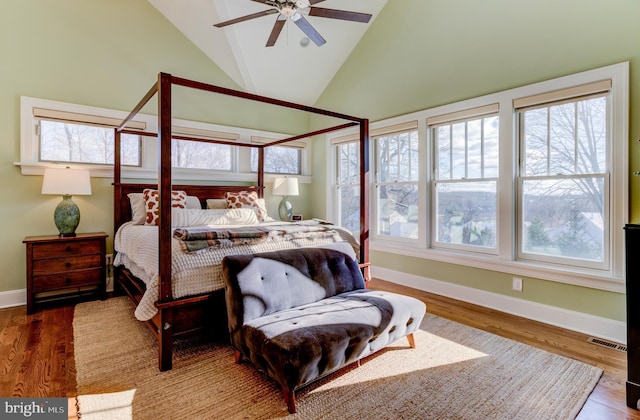 bedroom with wood-type flooring, high vaulted ceiling, and ceiling fan