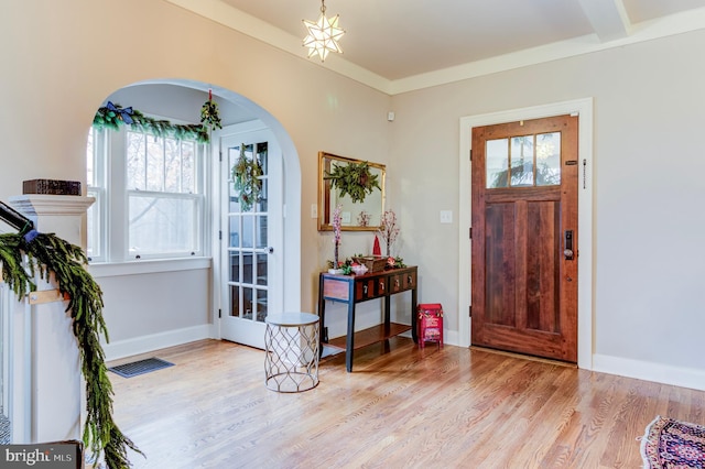 entrance foyer with light hardwood / wood-style floors and ornamental molding