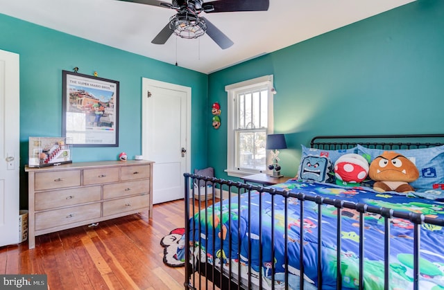 bedroom featuring hardwood / wood-style floors and ceiling fan