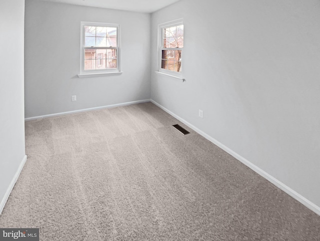 spare room with light carpet