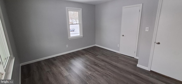 unfurnished bedroom with dark hardwood / wood-style flooring