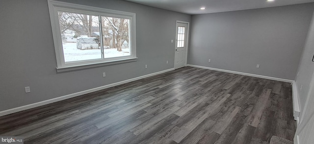 spare room with dark hardwood / wood-style floors