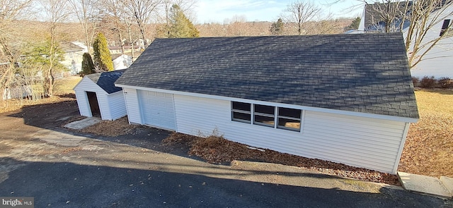 view of property exterior with an outbuilding and a garage