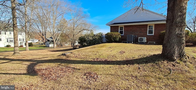 view of home's exterior featuring central AC unit and a yard