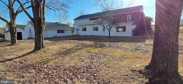 rear view of property featuring a balcony