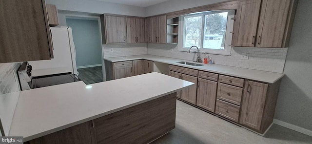 kitchen with kitchen peninsula, stove, and sink