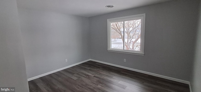 spare room with dark hardwood / wood-style floors