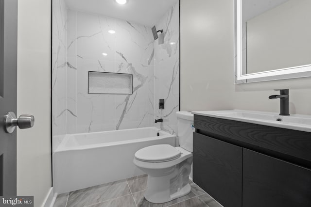 full bathroom with vanity, toilet, and tiled shower / bath