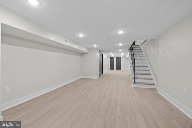 basement with light hardwood / wood-style floors