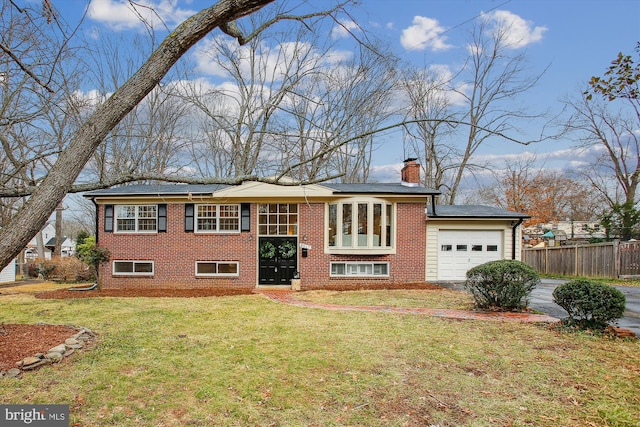 split foyer home with a garage and a front lawn