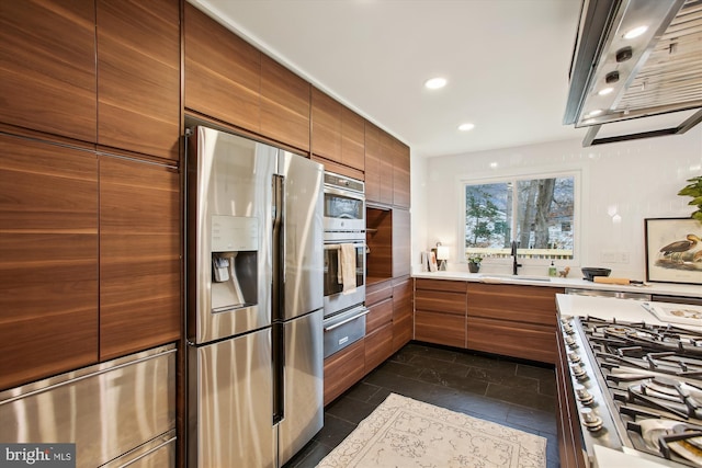 kitchen with appliances with stainless steel finishes, range hood, and sink