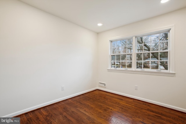 spare room featuring wood-type flooring