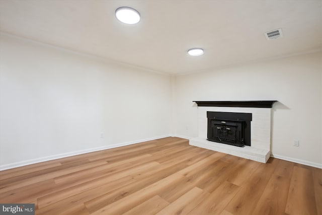 unfurnished living room with a fireplace and wood-type flooring