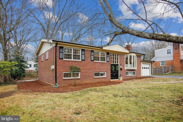 bi-level home featuring a front lawn and a garage