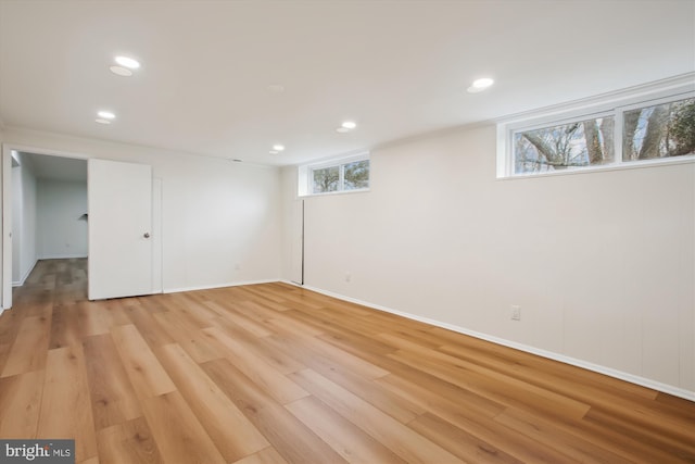 basement with light hardwood / wood-style floors