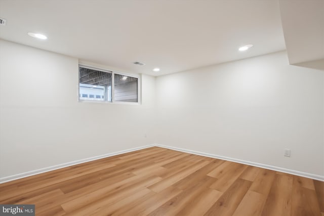 basement with hardwood / wood-style floors