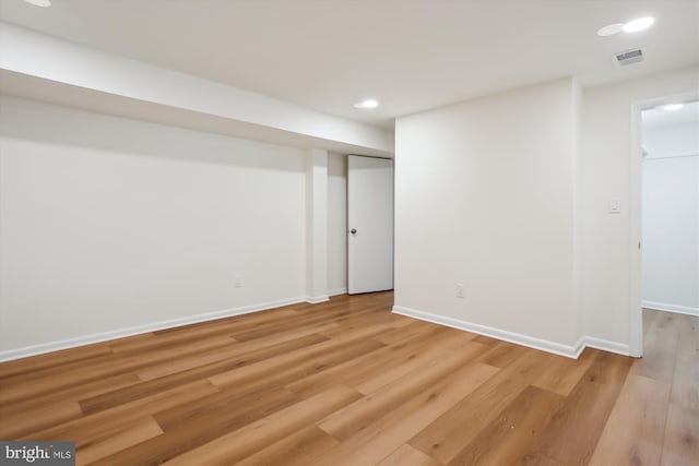 basement with light hardwood / wood-style flooring