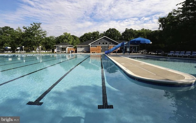 view of swimming pool with a water slide