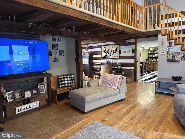 living room with hardwood / wood-style floors and a high ceiling