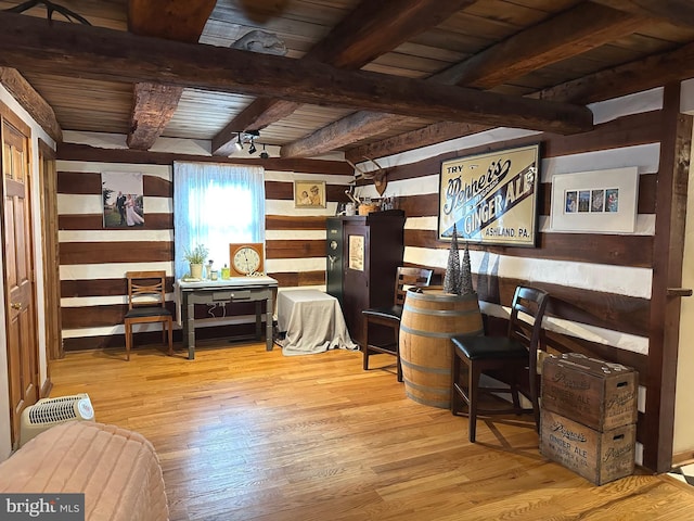 interior space with beam ceiling, light hardwood / wood-style flooring, and wooden ceiling