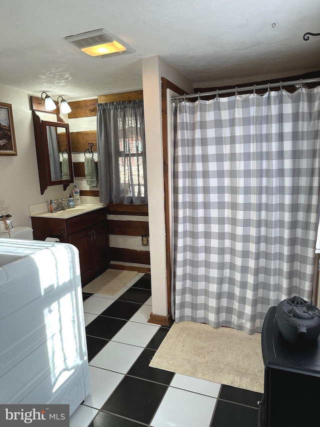 bathroom featuring tile patterned flooring and vanity