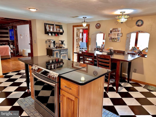 kitchen with a center island and stainless steel range with electric cooktop