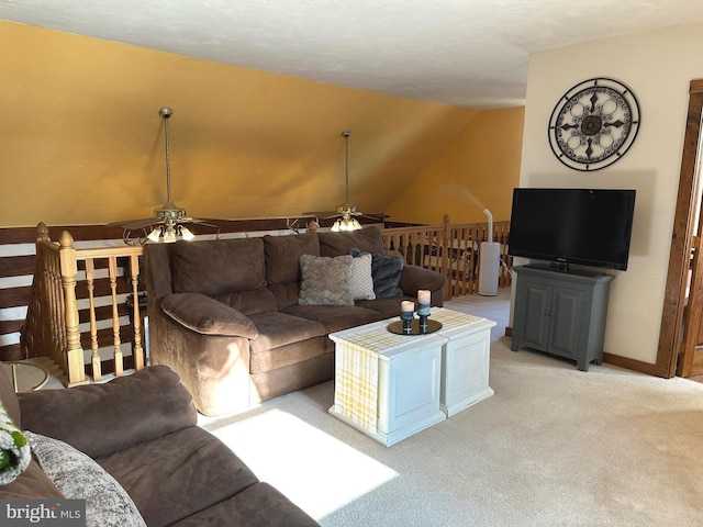 carpeted living room featuring ceiling fan and lofted ceiling