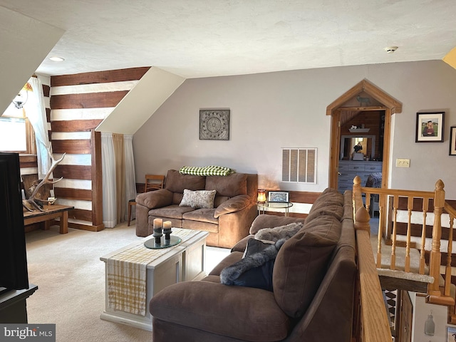 carpeted living room with lofted ceiling