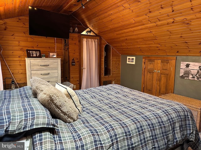 bedroom with wooden ceiling, wooden walls, and vaulted ceiling