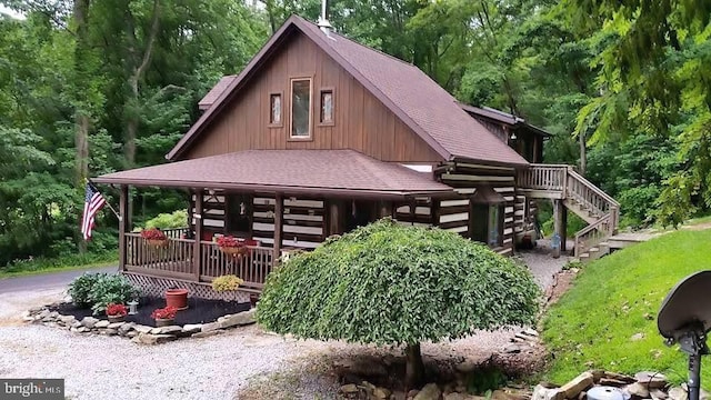 view of side of home with covered porch