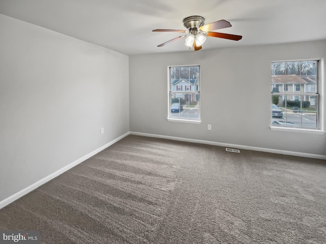 empty room featuring carpet flooring and ceiling fan