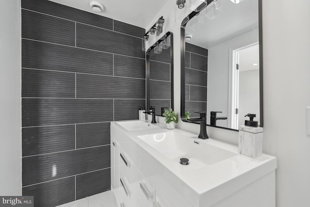 bathroom with vanity and tile walls