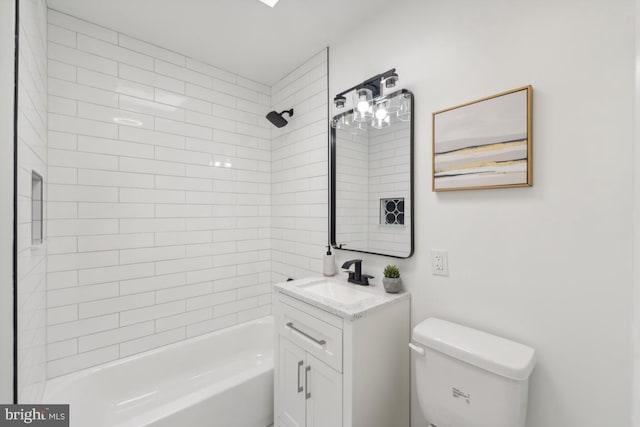 full bathroom with vanity, tiled shower / bath combo, and toilet