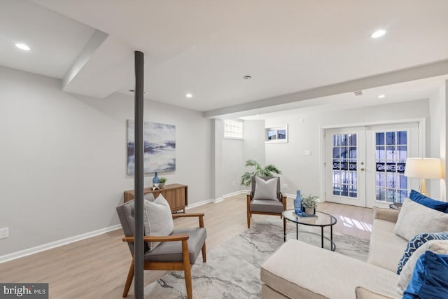 living room with french doors and light wood-type flooring