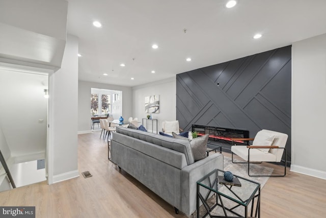 living room with a fireplace and light hardwood / wood-style flooring