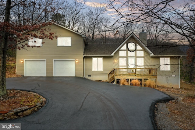 view of front of house featuring a garage and a wooden deck