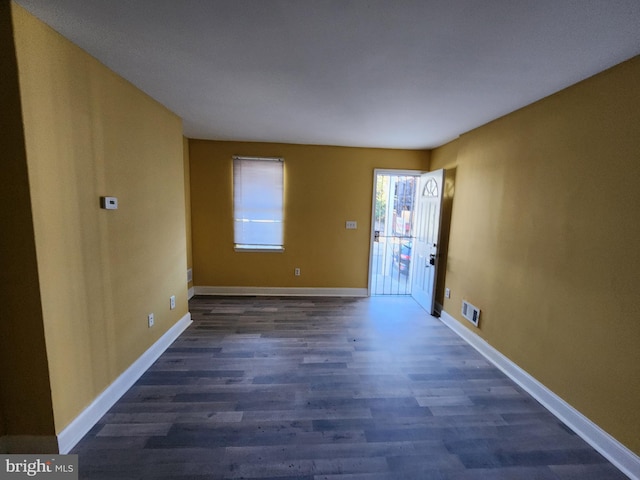 unfurnished room featuring dark hardwood / wood-style flooring