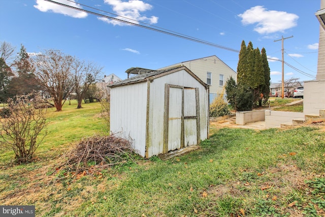 view of outbuilding featuring a yard